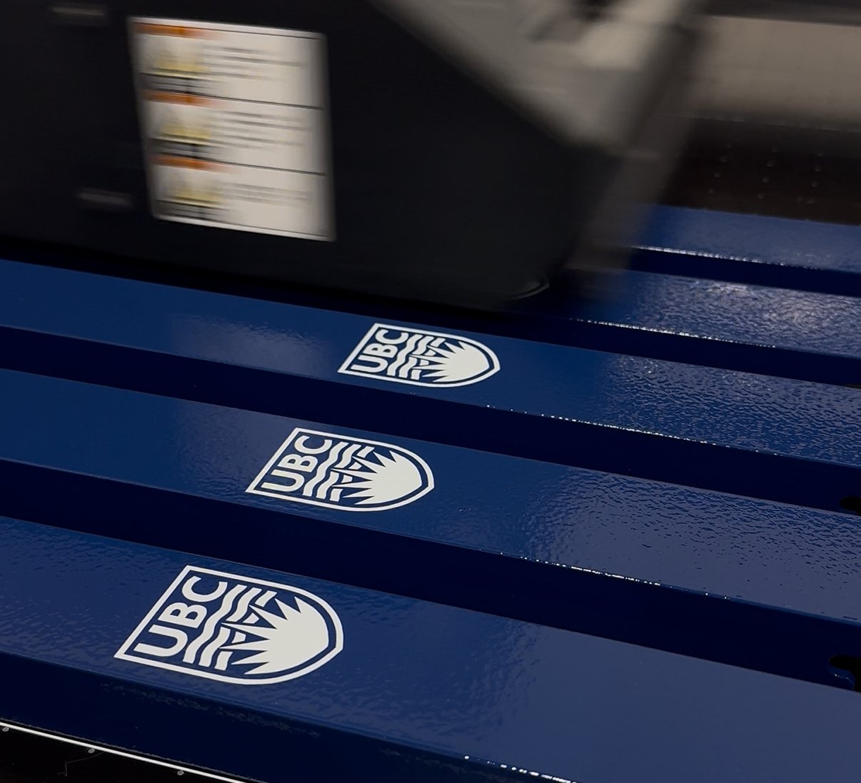 Custom-printed UBC signage panels produced on large-format printer at Can-Design facility.