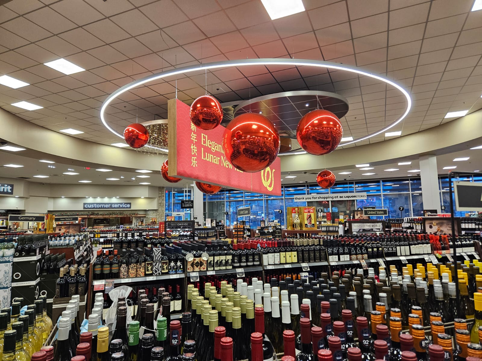 Seasonal Lunar New Year hanging banner with red lanterns inside BC Liquor Cambie store.