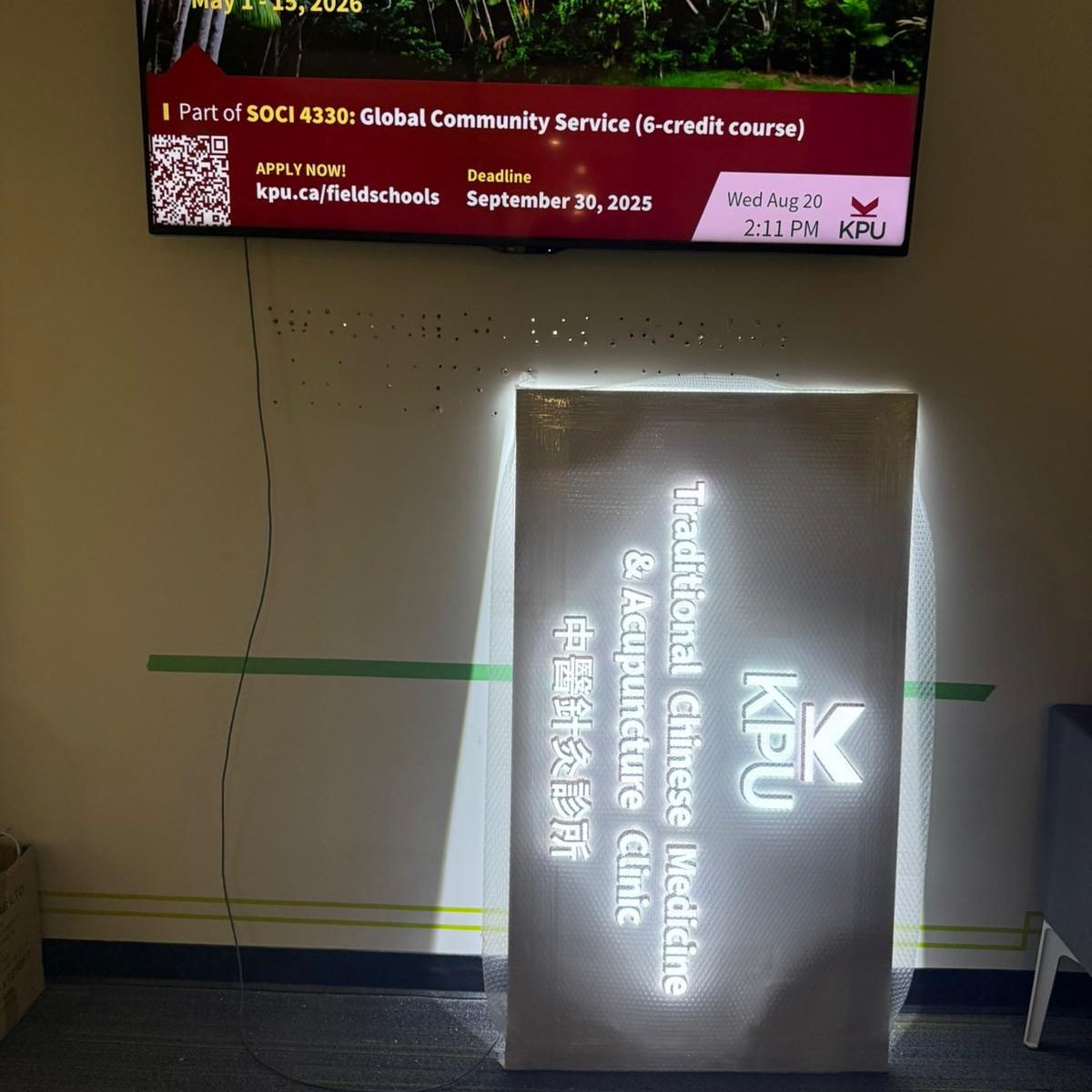 Backlit installation of KPU Traditional Chinese Medicine & Acupuncture Clinic signage panel.