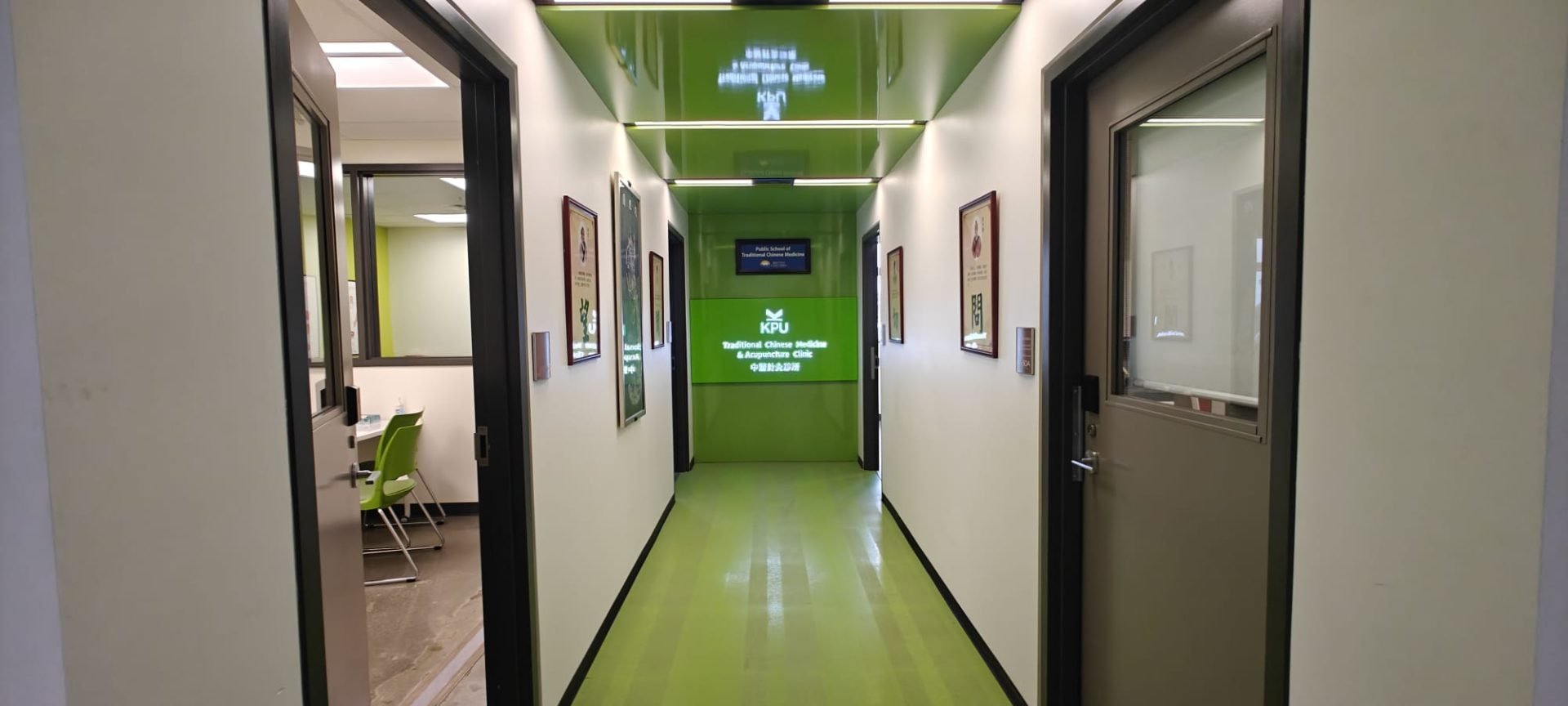 Interior hallway view with illuminated KPU Traditional Chinese Medicine Clinic signage at corridor entrance.
